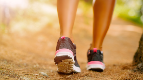 Woman walking briskly outdoors.